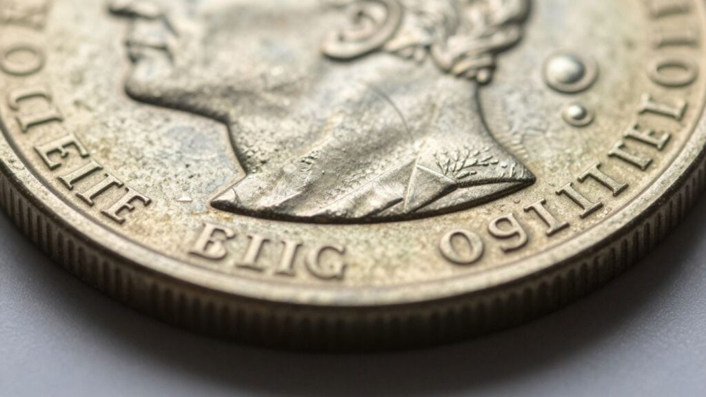 Close-up of coin edge with intricate patterns and textures.